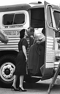 Louise and Earl Scruggs kiss as he boards a bus